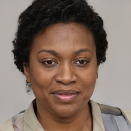 Joyful black adult female with short  brown hair and brown eyes