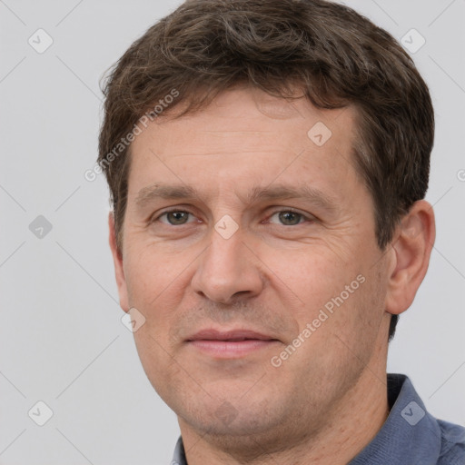 Joyful white adult male with short  brown hair and grey eyes