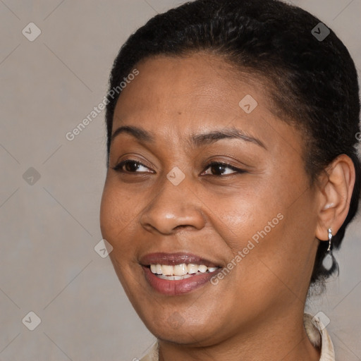 Joyful black adult female with short  brown hair and brown eyes