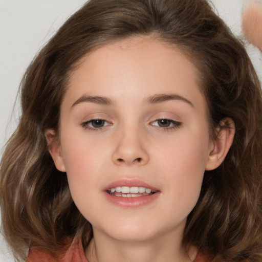 Joyful white child female with medium  brown hair and brown eyes