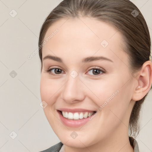 Joyful white young-adult female with long  brown hair and brown eyes