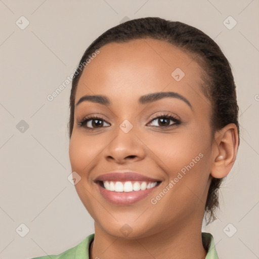 Joyful latino young-adult female with long  brown hair and brown eyes