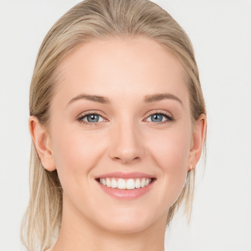 Joyful white young-adult female with medium  brown hair and blue eyes