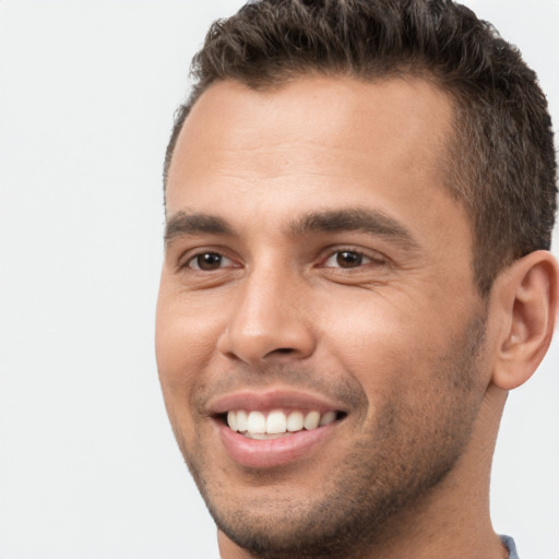 Joyful white young-adult male with short  brown hair and brown eyes