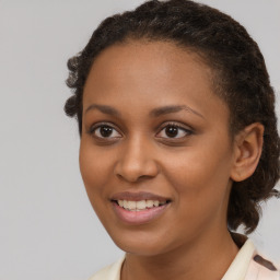 Joyful black young-adult female with medium  brown hair and brown eyes