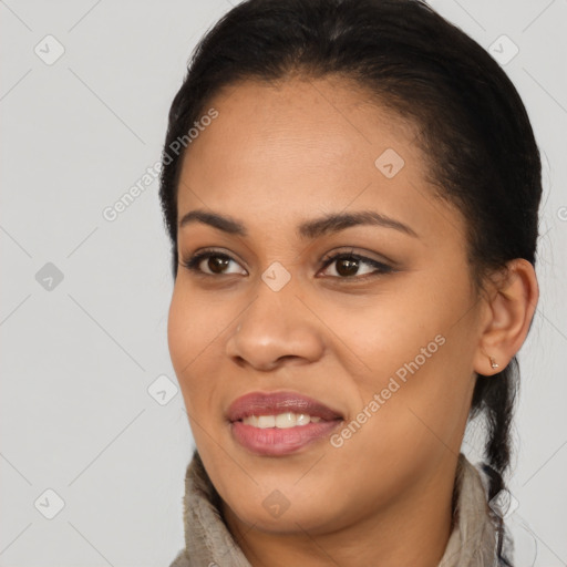 Joyful latino young-adult female with long  black hair and brown eyes