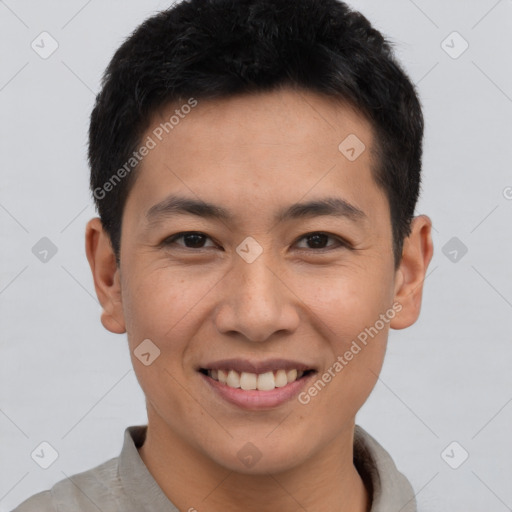 Joyful asian young-adult male with short  brown hair and brown eyes