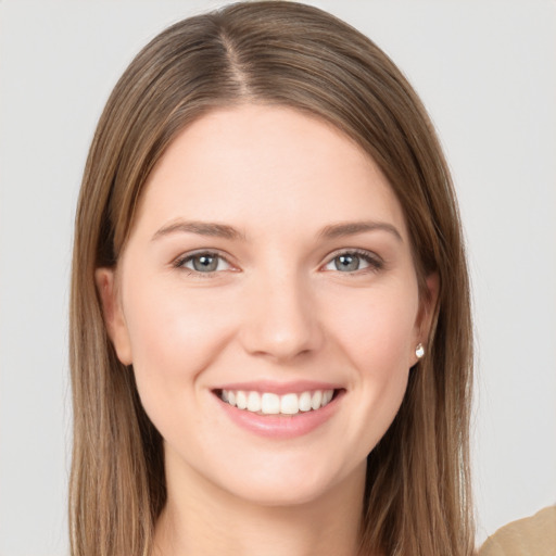 Joyful white young-adult female with long  brown hair and grey eyes