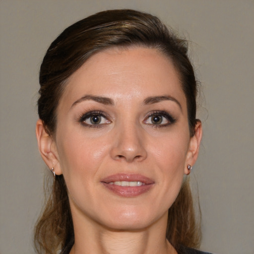 Joyful white young-adult female with medium  brown hair and brown eyes