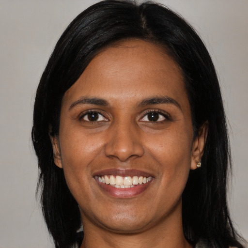 Joyful black young-adult female with medium  black hair and brown eyes