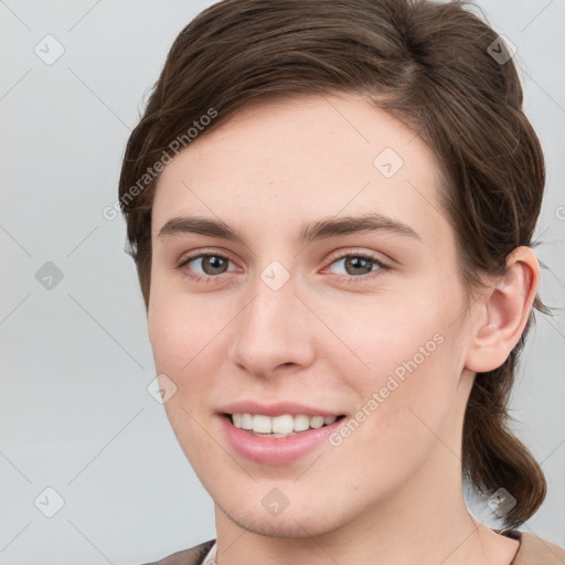 Joyful white young-adult female with short  brown hair and grey eyes