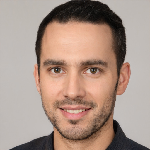 Joyful white young-adult male with short  black hair and brown eyes