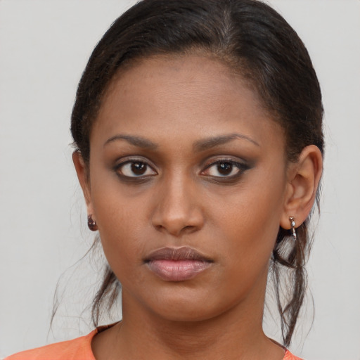 Neutral black young-adult female with medium  brown hair and brown eyes