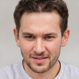 Joyful white adult male with short  brown hair and brown eyes