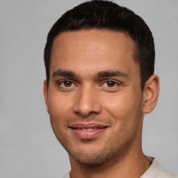 Joyful white young-adult male with short  black hair and brown eyes