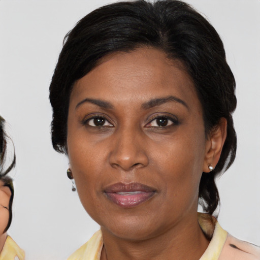 Joyful asian adult female with medium  brown hair and brown eyes