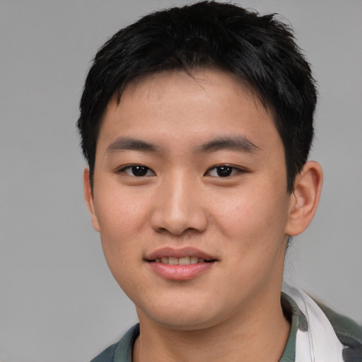 Joyful asian young-adult male with short  black hair and brown eyes