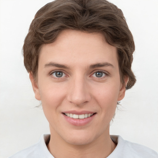 Joyful white young-adult female with short  brown hair and grey eyes