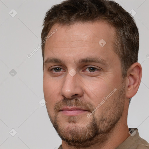 Joyful white adult male with short  brown hair and brown eyes