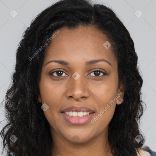 Joyful black young-adult female with long  brown hair and brown eyes