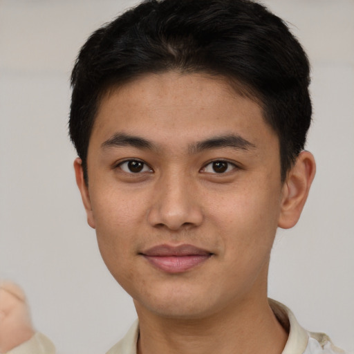 Joyful asian young-adult male with short  brown hair and brown eyes