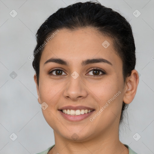 Joyful latino young-adult female with short  brown hair and brown eyes