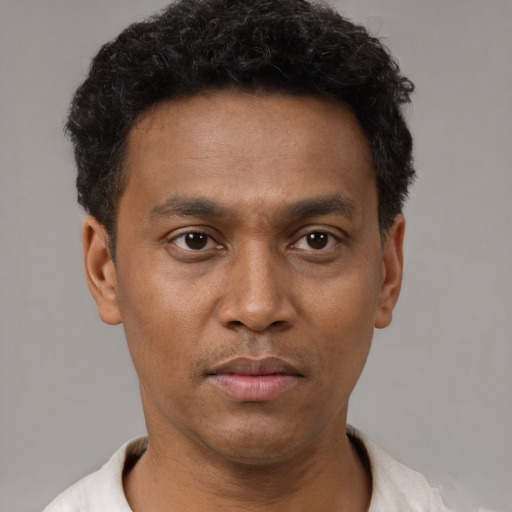 Neutral black young-adult male with short  black hair and brown eyes
