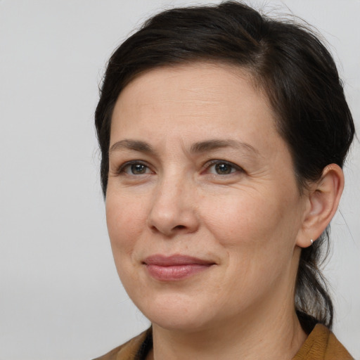 Joyful white adult female with medium  brown hair and brown eyes