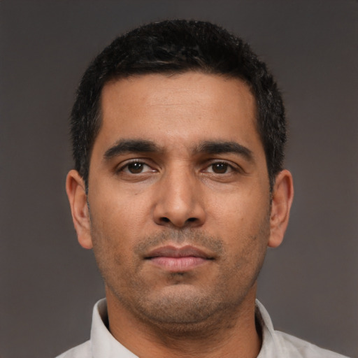 Neutral latino young-adult male with short  black hair and brown eyes