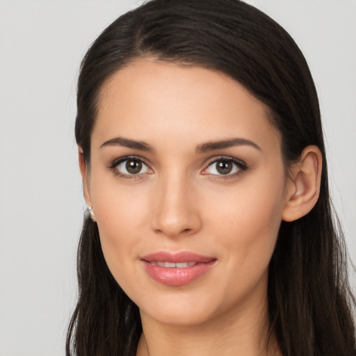 Joyful latino young-adult female with long  brown hair and brown eyes