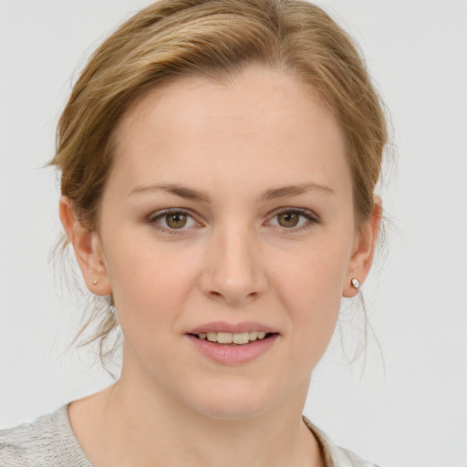 Joyful white young-adult female with medium  brown hair and blue eyes