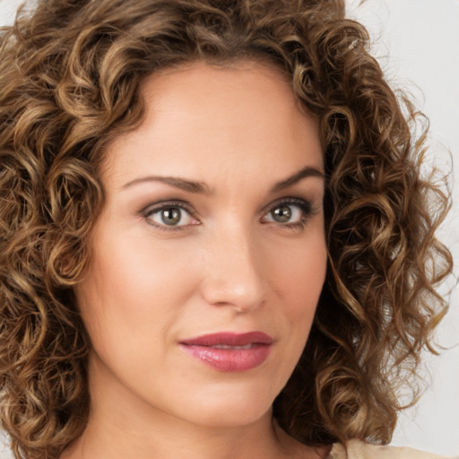 Joyful white young-adult female with long  brown hair and green eyes