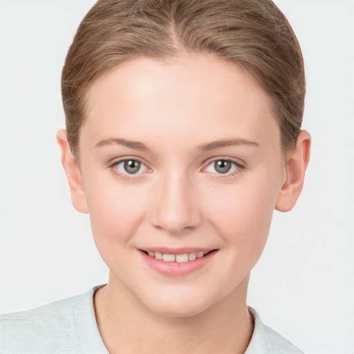 Joyful white young-adult female with short  brown hair and blue eyes