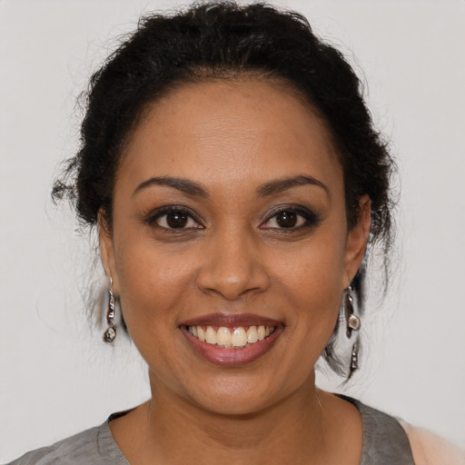 Joyful latino young-adult female with short  brown hair and brown eyes