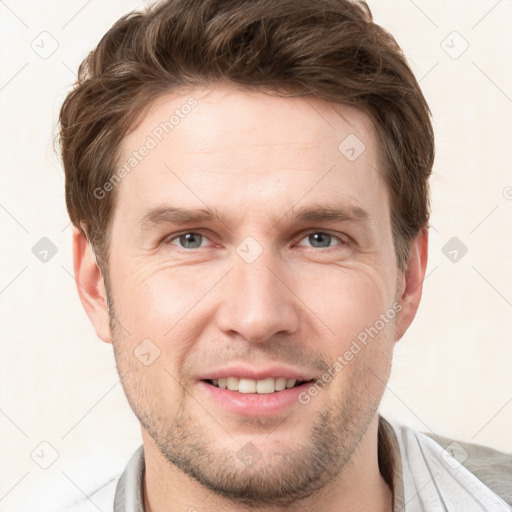 Joyful white young-adult male with short  brown hair and grey eyes