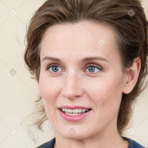 Joyful white young-adult female with medium  brown hair and green eyes