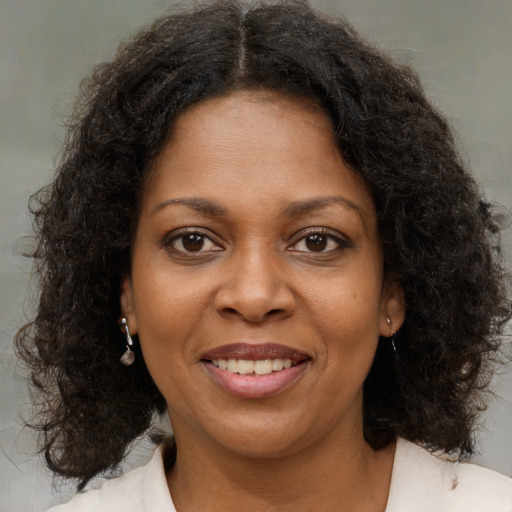 Joyful black young-adult female with medium  brown hair and brown eyes