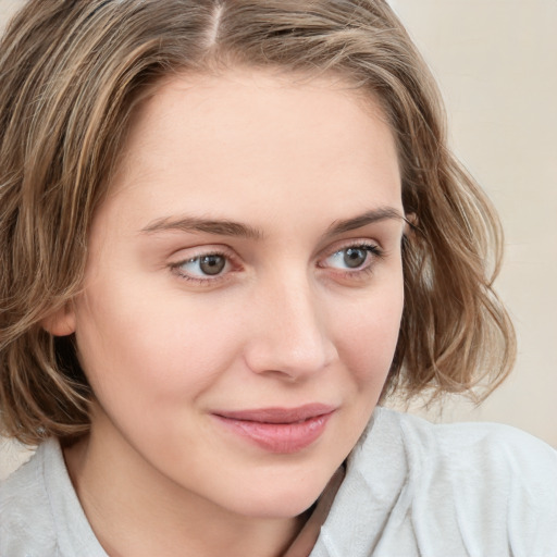 Joyful white young-adult female with medium  brown hair and blue eyes