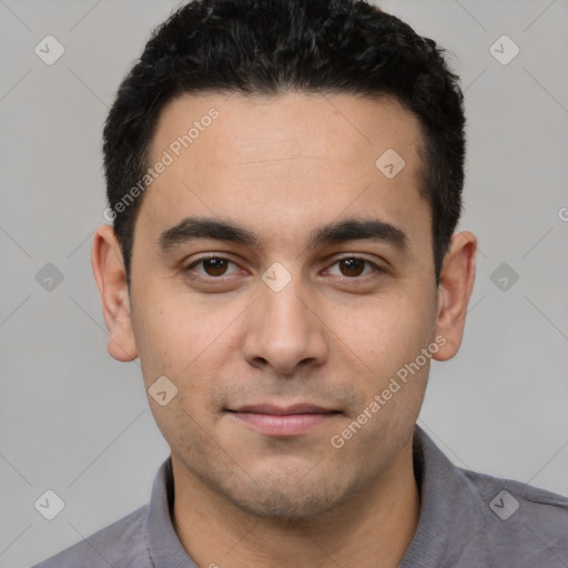 Joyful white young-adult male with short  black hair and brown eyes