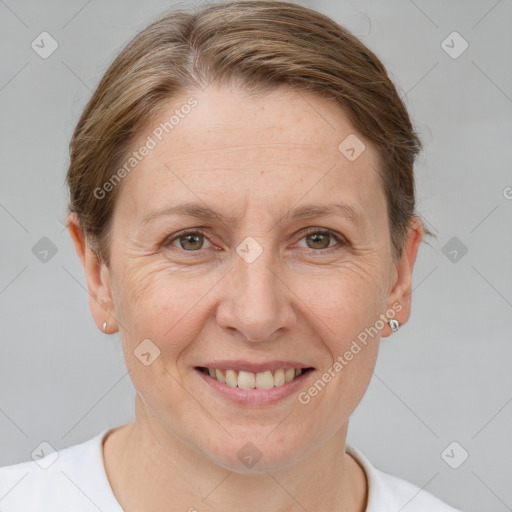 Joyful white adult female with short  brown hair and brown eyes