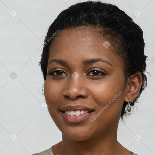 Joyful black young-adult female with short  black hair and brown eyes