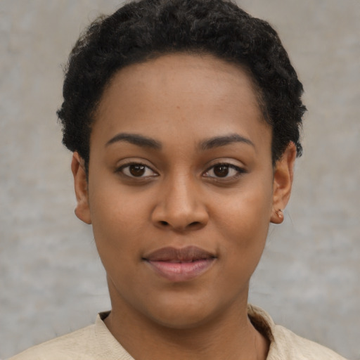 Joyful black young-adult female with short  black hair and brown eyes