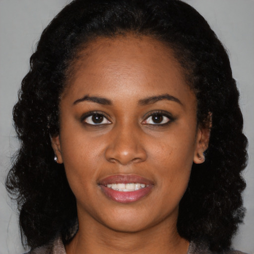Joyful black young-adult female with medium  black hair and brown eyes