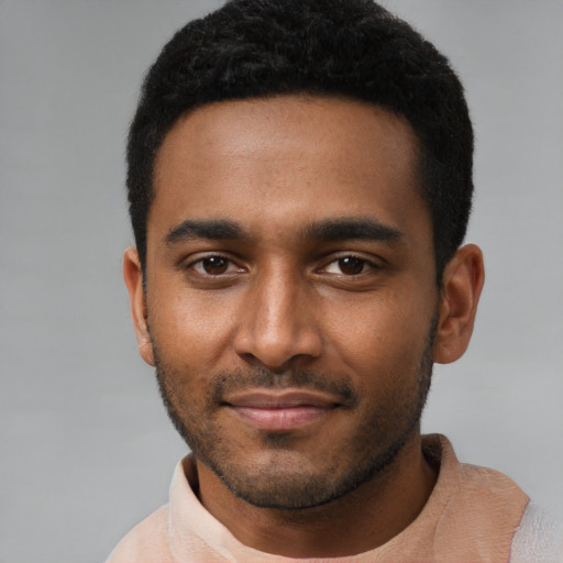 Joyful black young-adult male with short  black hair and brown eyes