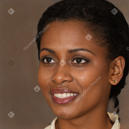 Joyful black young-adult female with short  brown hair and brown eyes