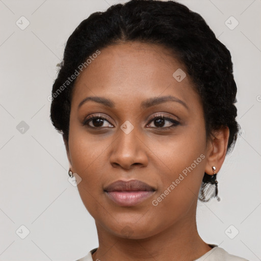 Joyful black young-adult female with short  black hair and brown eyes