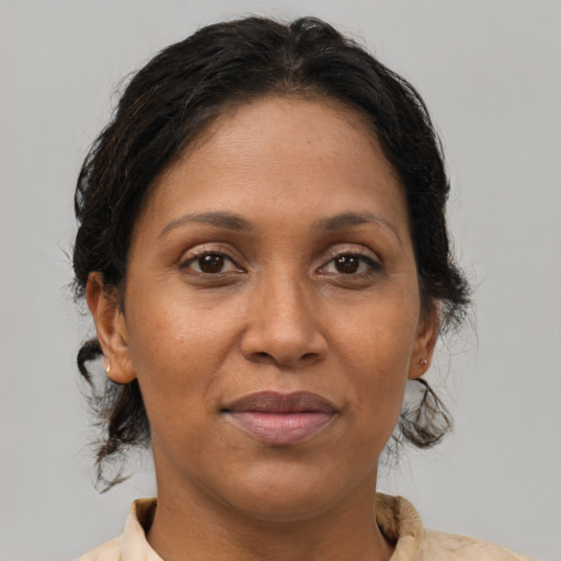 Joyful latino adult female with medium  brown hair and brown eyes