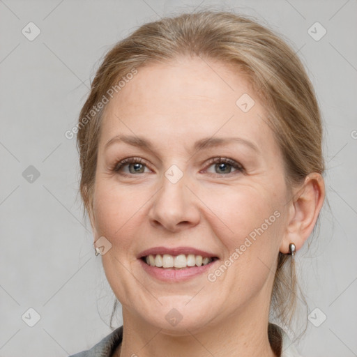 Joyful white adult female with medium  brown hair and grey eyes