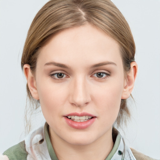 Joyful white young-adult female with medium  brown hair and blue eyes