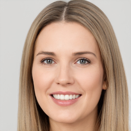 Joyful white young-adult female with long  brown hair and brown eyes